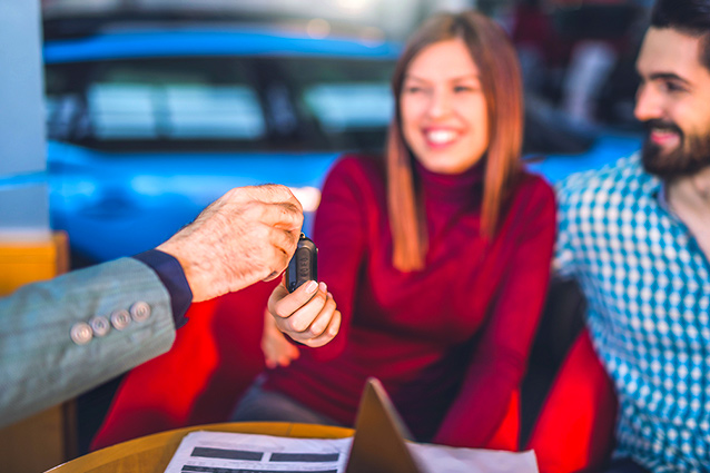 a man giving a key to their adult children